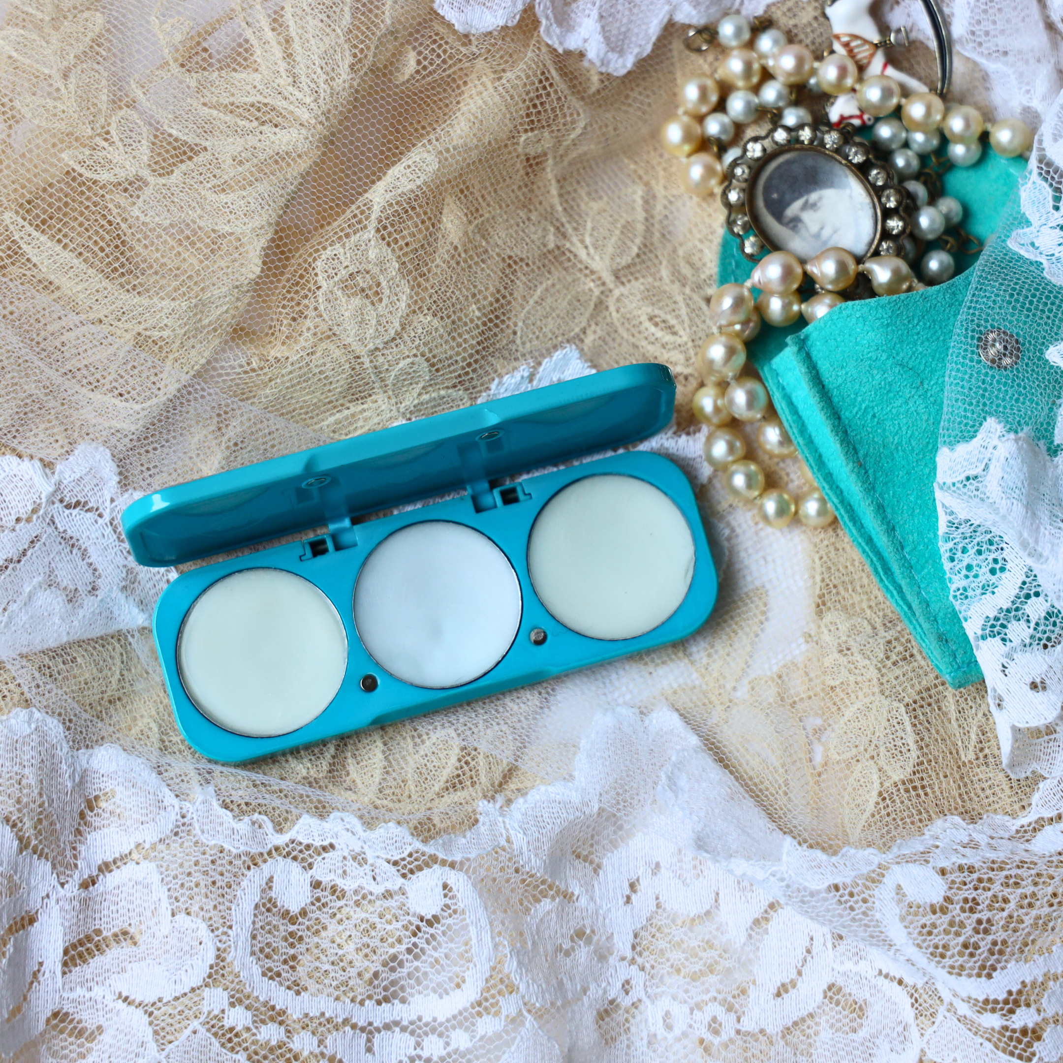 ema fragrance refillable perfume compact in teal blue