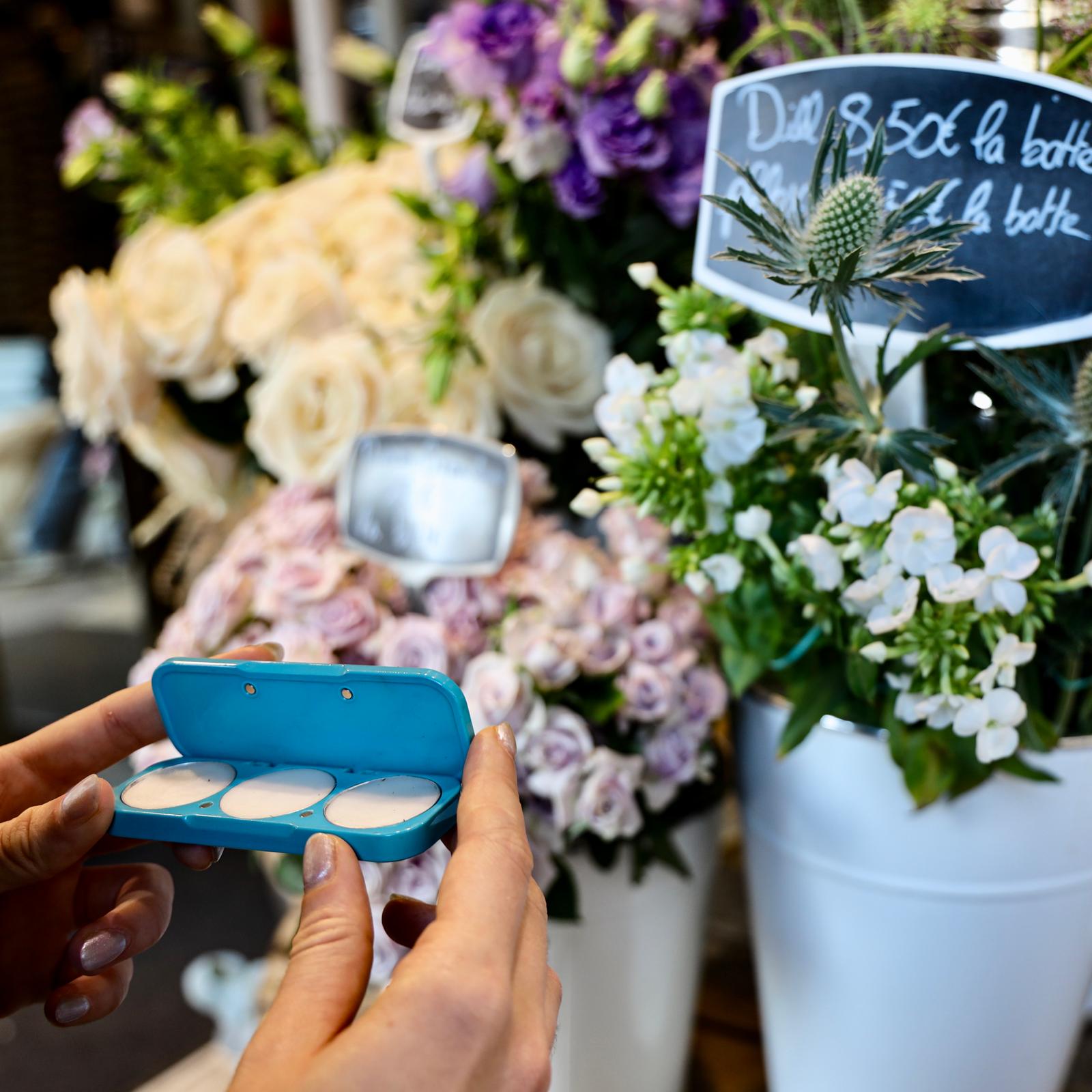 Solid perfume compact against flowers, in Paris