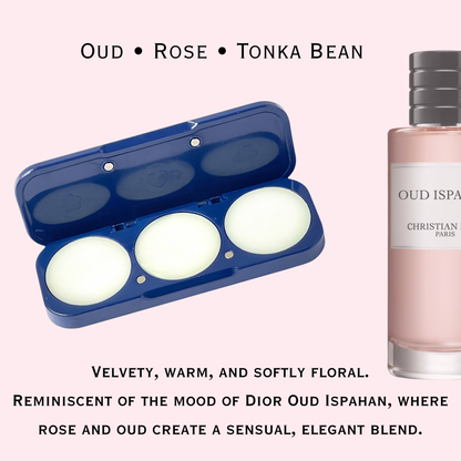 Perfume bottle labeled 'Oud Rose Tonka Bean' next to an open solid fragrance compact on a light pink background.